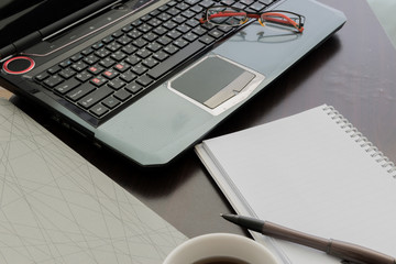 laptop, Document file , pen , Calculator , notepad and glasses o