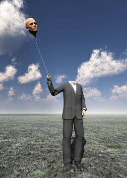 Head less man holds balloon head