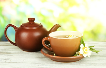 Fototapeta na wymiar Cup of tea with jasmine, on bright background