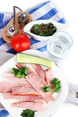 Bacon on plates on napkin on board isolated on white