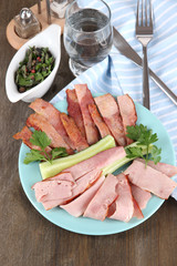 Bacon on plate on napkin on board on window table