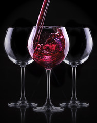 Elegant red wine glass in black background