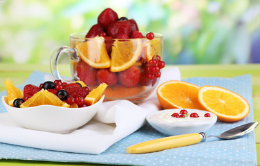 Useful fruit salad in glass cup and bowl