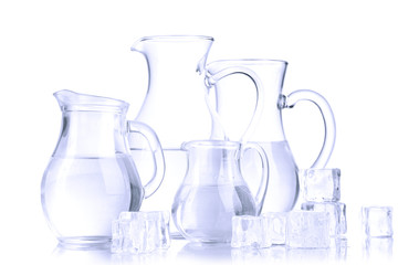 Glass pitchers of water isolated on white