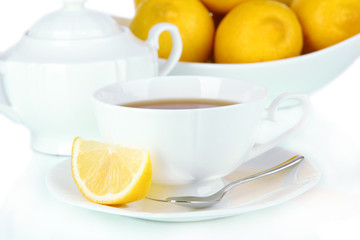 Cup of tea with lemon isolated on white