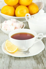 Cup of tea with lemon on table close-up
