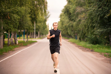 Sportive young man jogging outdoor