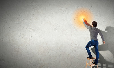 Young man with an electric light bulb