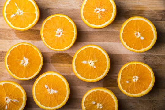 half oranges on a wooden plate