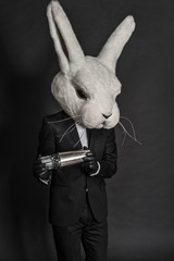 man in hare mask . black suit barman on gray background - 54867622