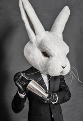 man in hare mask . black suit barman on gray background - 54867635
