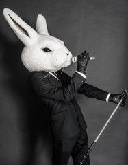 man in rabbit mask . black suit sing on dark background - 54867639