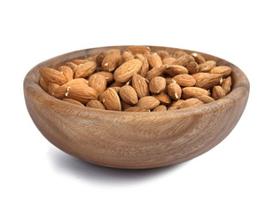 almonds in wooden bowl isolated on white