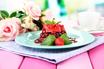 Tasty jelly dessert with fresh berries, on bright background