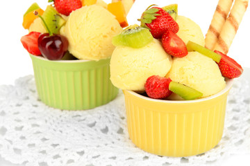 Delicious  ice cream with fruits and berries in bowl close up