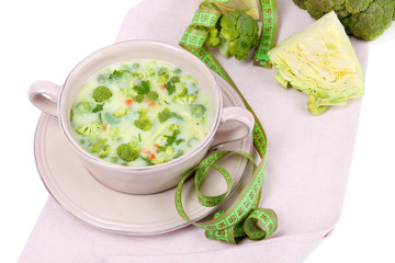 Cabbage soup in plate on napkin isolated on white
