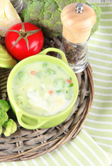 Cabbage soup in plates on braided tray on napkin on wooden
