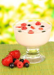 Delicious yogurt with fruit on table on bright background