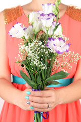 Woman holding bouquet of roses, on bright background, close-up