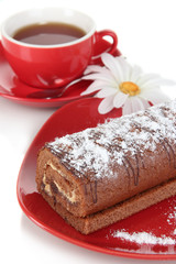 Sweet roll with cup of tea isolated on white