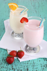 Delicious milk shakes with orange and strawberries
