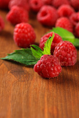 Ripe sweet raspberries on wooden background