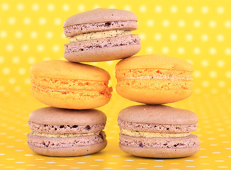 Gentle macaroons on yellow background