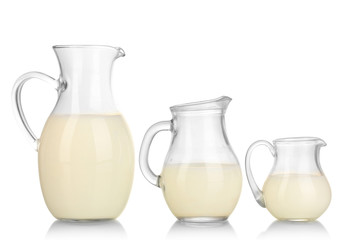 Milk in jugs isolated on white
