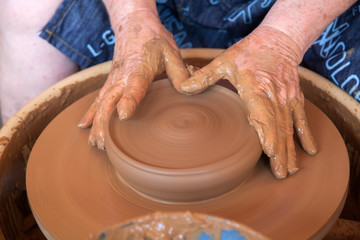 Potter works with clay in ceramics studio