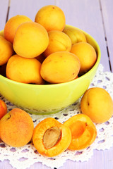 Fresh natural apricot in bowl on wooden table