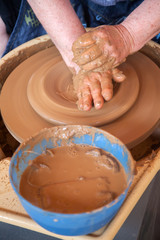 Potter works with clay in ceramics studio