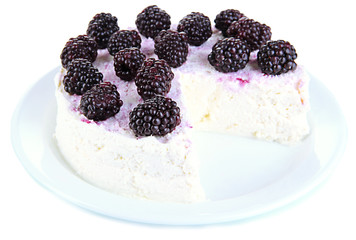 Cheesecake with fresh berries on white plate closeup