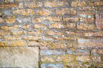 Weathered limestone wall made of the stones of different shape