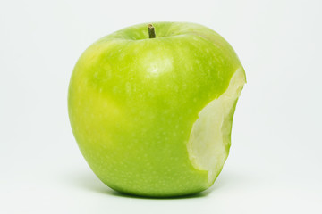 Green apple with one bite