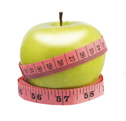 Green apple and measuring tape. Diet concept