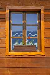 Fototapeta na wymiar Window of wooden cottage close up