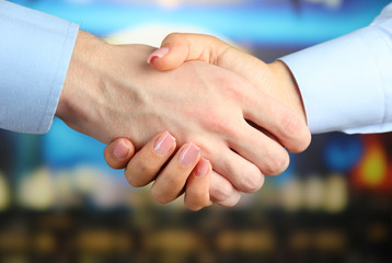 Business handshake on bright background