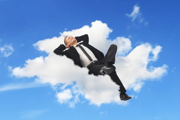 Businessman sleeping in a cloud