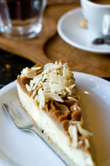 Delicious cheese cake, black coffee and a glass of water