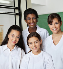 Teacher Standing With Schoolgirls In Lab