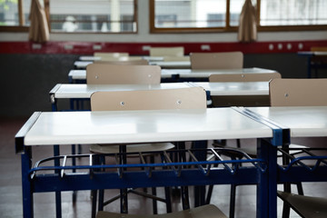 Empty Classroom With Chairs And Desks