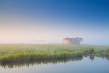 little house in morning fog