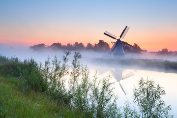 charming Dutch windmill by river