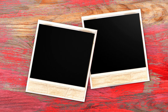old photo frames over rustic wooden background