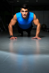 Fototapeta na wymiar Man exercising in gym push ups