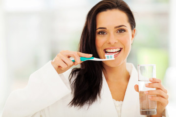 cute woman brushes her teeth