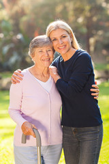 mature woman with her senior mother outdoors
