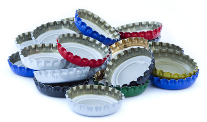 A stack of metal bottle caps isolated on white background.