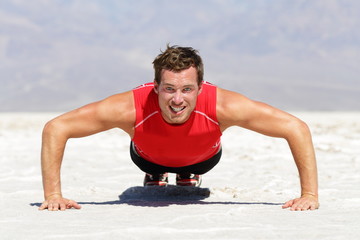 Fitness man doing push ups training outdoor