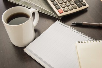 Coffee cup, Document file , pen , Calculator , notepad  on woode